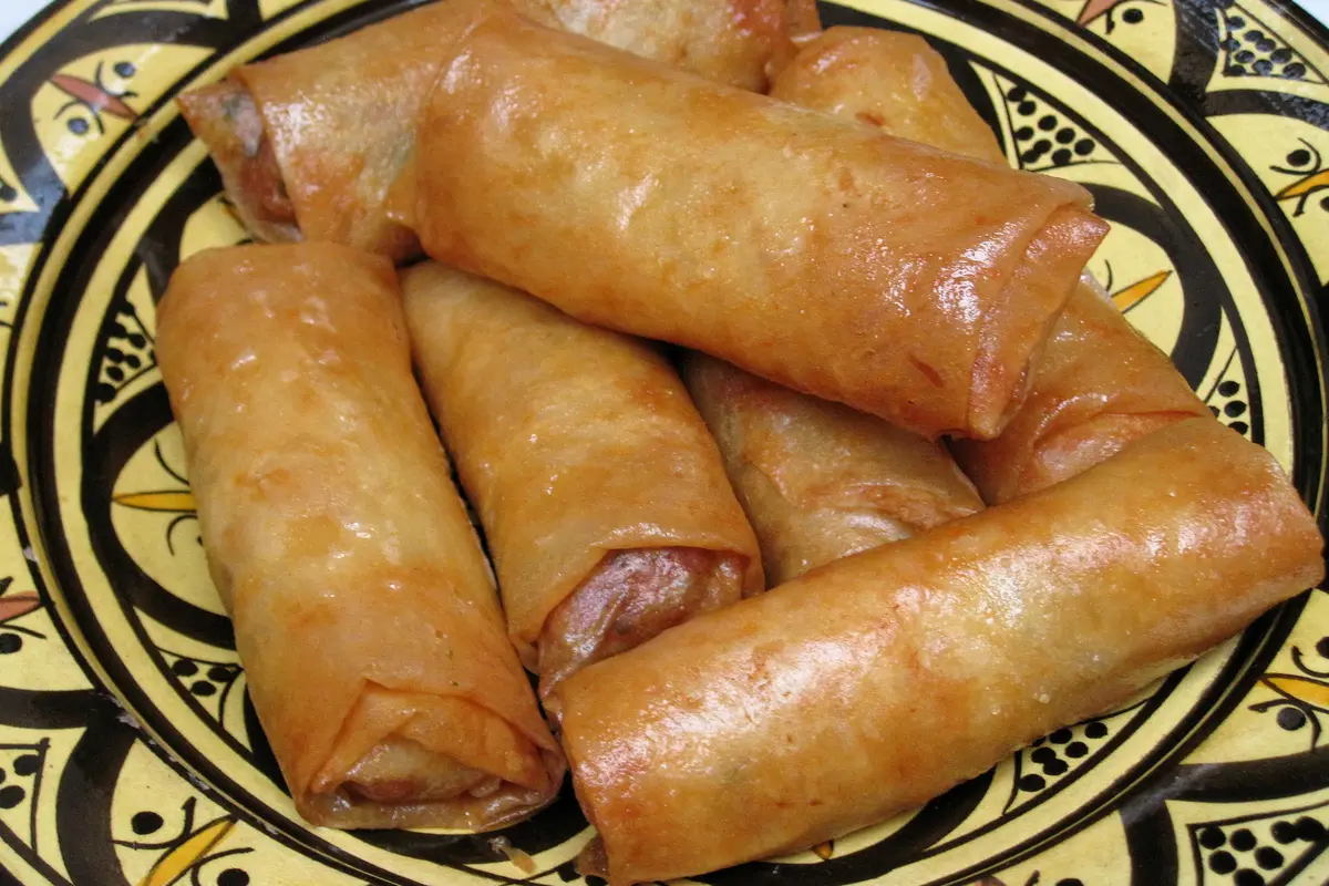 Golden fried Moroccan briouat pastries drizzled with honey
