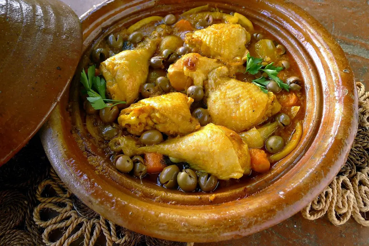 Moroccan chicken tagine with preserved lemon and olives in a traditional clay pot