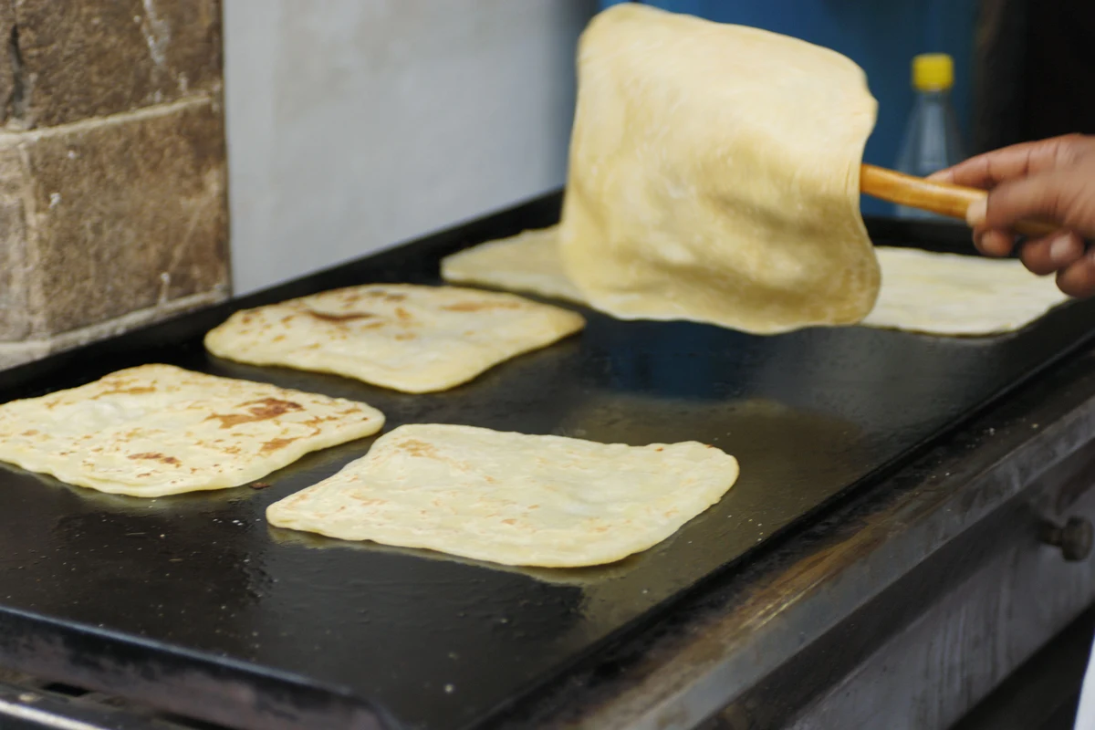 Crispy layered Moroccan Msemen served warm with honey and mint tea